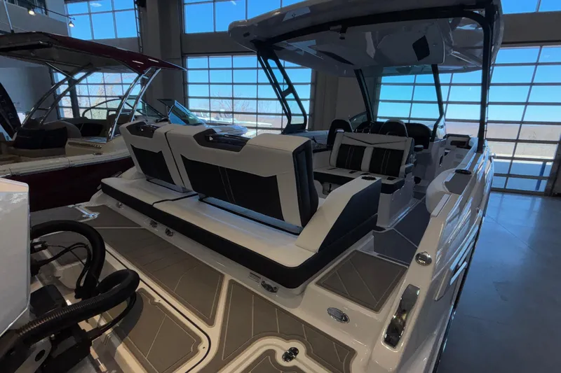 Slide: The Image of 2026 Monterey Elite 30 OB boat interior with luxurious seating in showroom. - 11