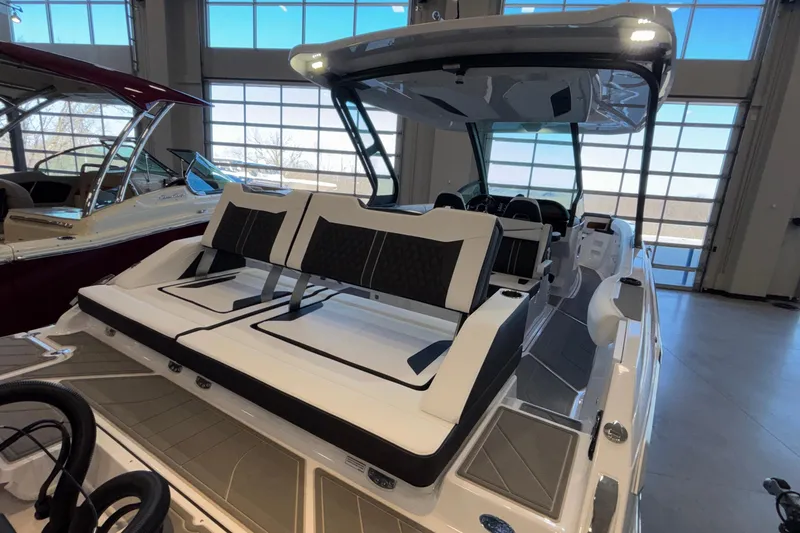Slide: The Image of 2026 Monterey Elite 30 OB boat with sleek seating and modern design in showroom. - 22