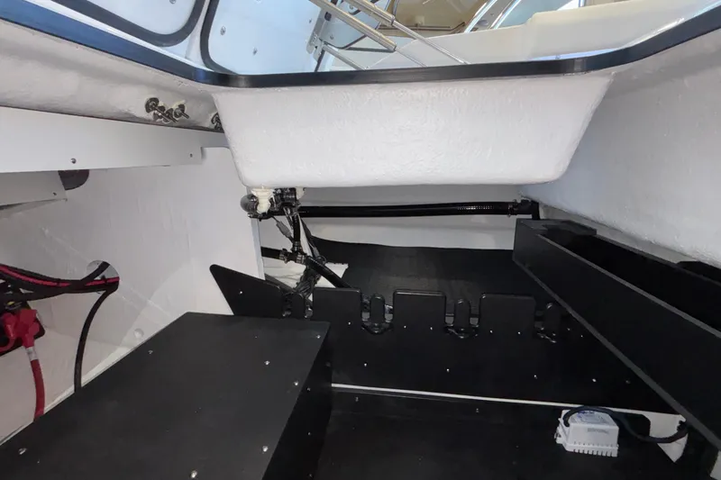 Slide: The Image of 2026 Monterey Elite 30 OB boat interior, showcasing storage and mechanical components. - 26