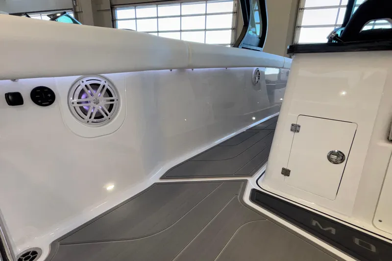 Slide: The Image of 2026 Monterey Elite 30 OB boat interior with sleek white seating and modern speaker system. - 30
