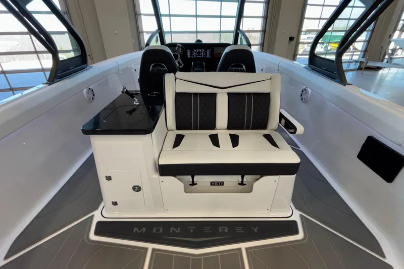 Slide: The Image of 2026 Monterey Elite 30 OB boat interior with sleek seating and modern design. - 31