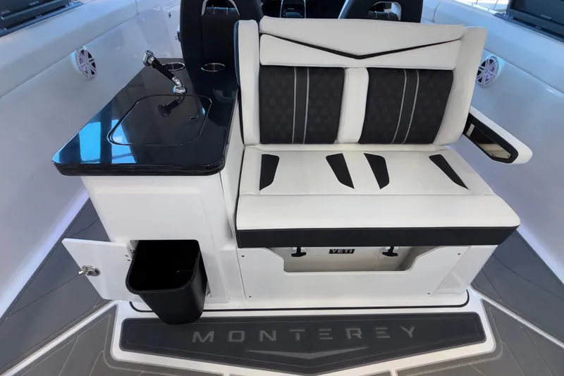 Slide: The Image of 2026 Monterey Elite 30 OB boat interior with sleek seating and modern design. - 33