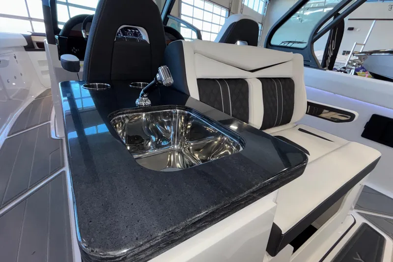 Slide: The Image of Luxury interior of 2026 Monterey Elite 30 OB boat with sleek sink and seating. - 34