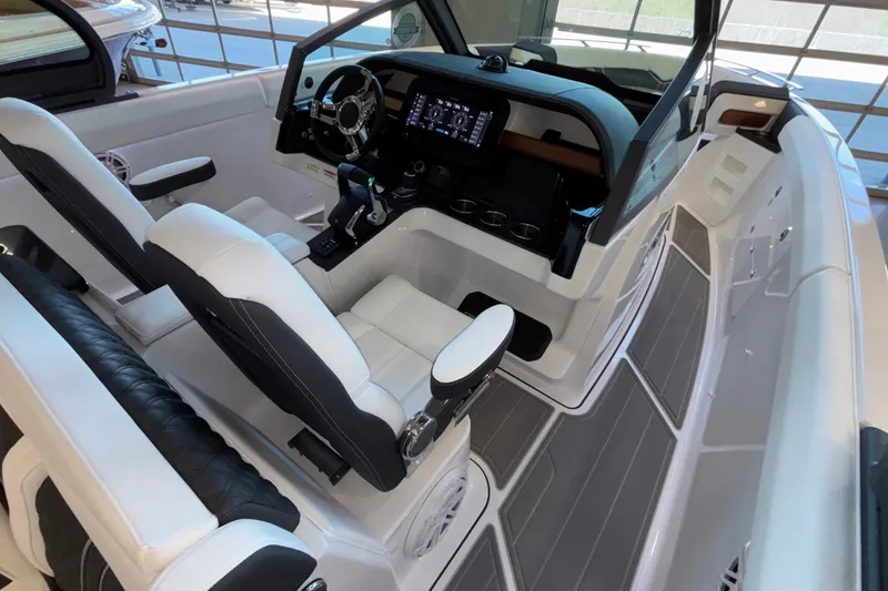 Slide: The Image of 2026 Monterey Elite 30 OB boat interior with modern dashboard and seating. - 37