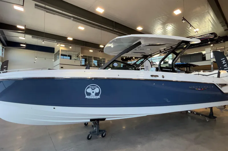 Slide: The Image of 2026 Monterey Elite 30 OB boat displayed indoors, featuring sleek design and modern amenities. - 4