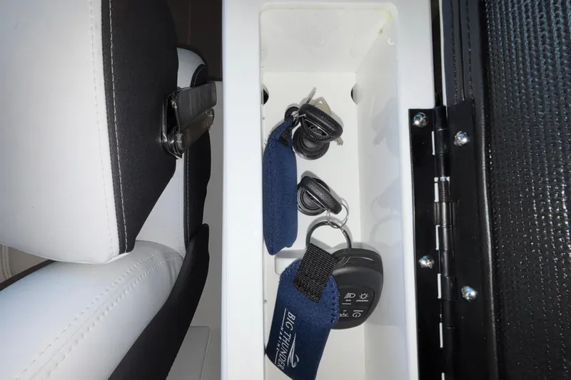 Slide: The Image of Storage compartment in 2026 Monterey Elite 30 OB boat with keys and keychains. - 45