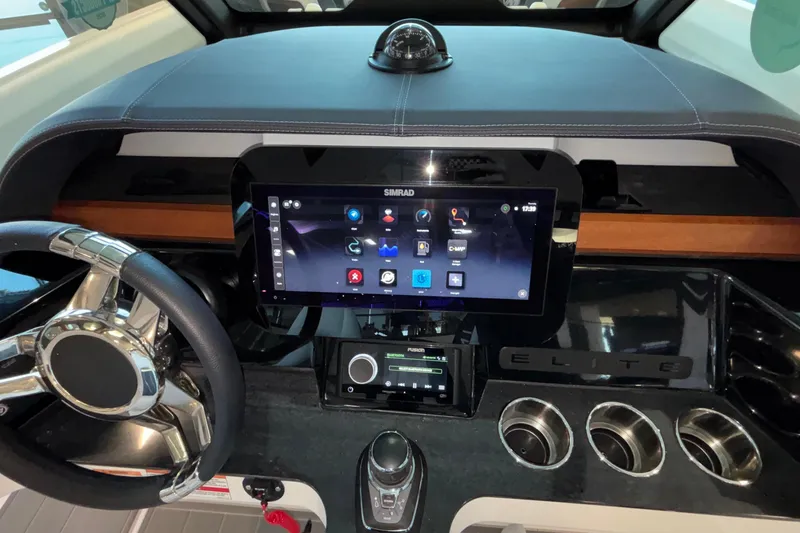 Slide: The Image of Dashboard of 2026 Monterey Elite 30 OB boat with touchscreen and steering wheel. - 52