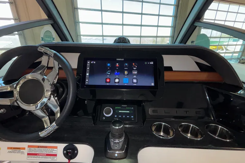 Slide: The Image of 2026 Monterey Elite 30 OB dashboard with touchscreen and steering wheel in a modern boat interior. - 53