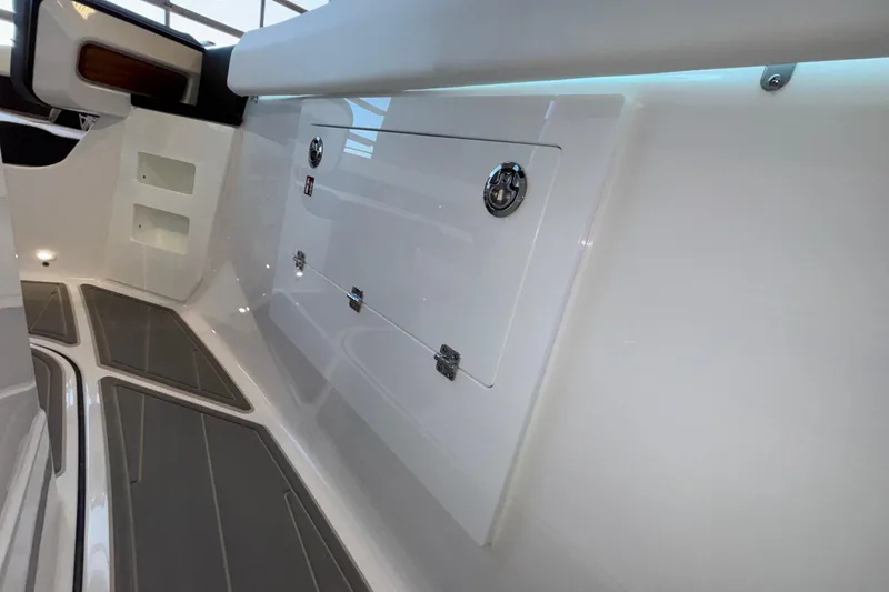 Slide: The Image of 2026 Monterey Elite 30 OB boat interior with sleek storage compartments and modern design. - 56