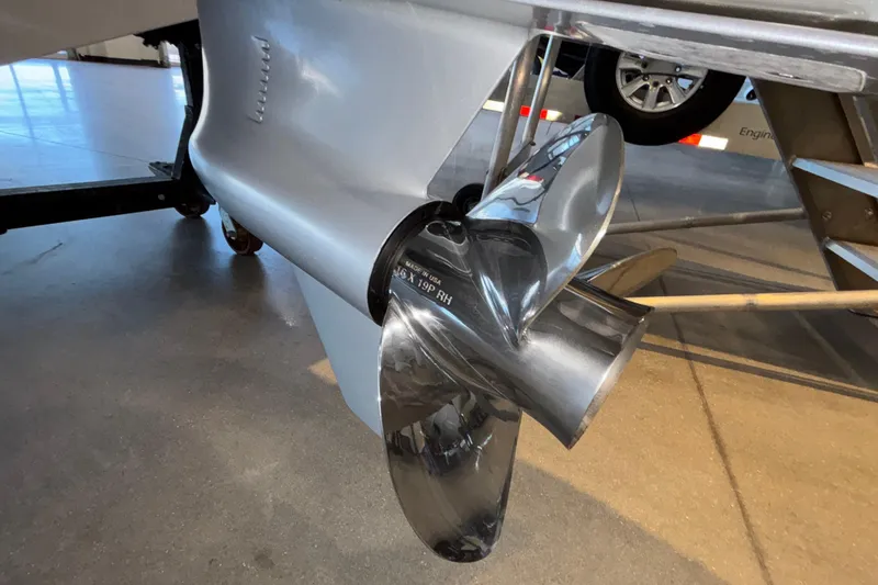 Slide: The Image of Close-up of a 2026 Monterey Elite 30 OB boat propeller in a showroom setting. - 7