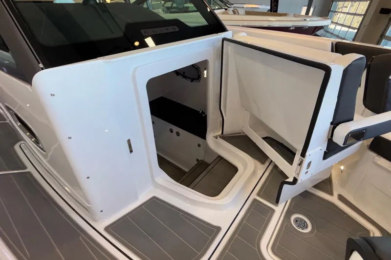 Slide: The Image of 2026 Monterey Elite 30 OB boat interior with open storage compartment and seating area. - 72