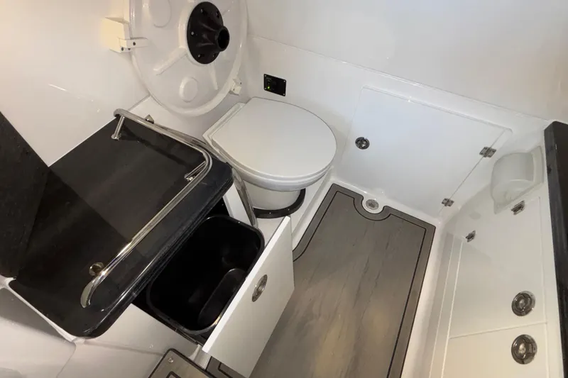 Slide: The Image of 2026 Monterey Elite 30 OB boat bathroom with modern fixtures and storage. - 77
