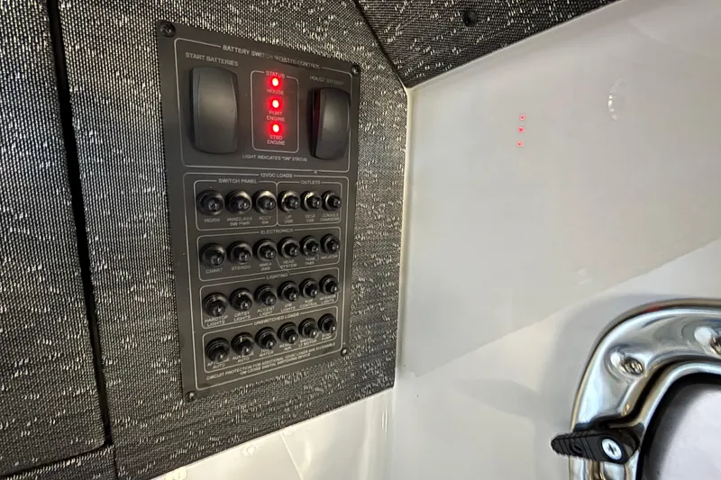 Slide: The Image of Control panel of 2026 Monterey Elite 30 OB boat with switches and indicators. - 81