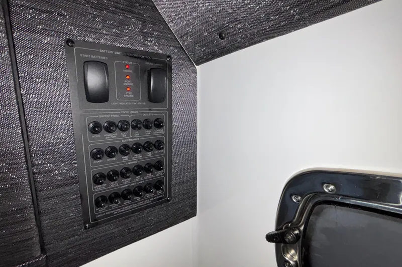 Slide: The Image of Control panel inside 2026 Monterey Elite 30 OB boat, featuring switches and battery indicators. - 82