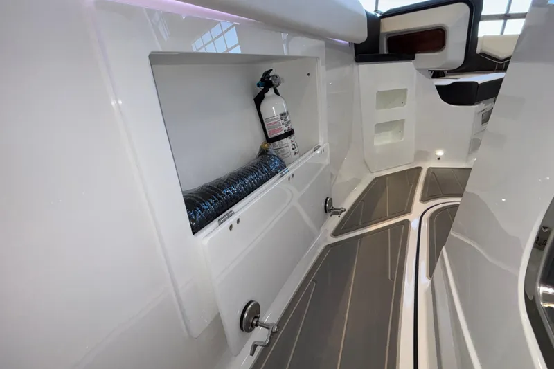 Slide: The Image of 2026 Monterey Elite 30 OB interior with storage compartment and fire extinguisher. - 86