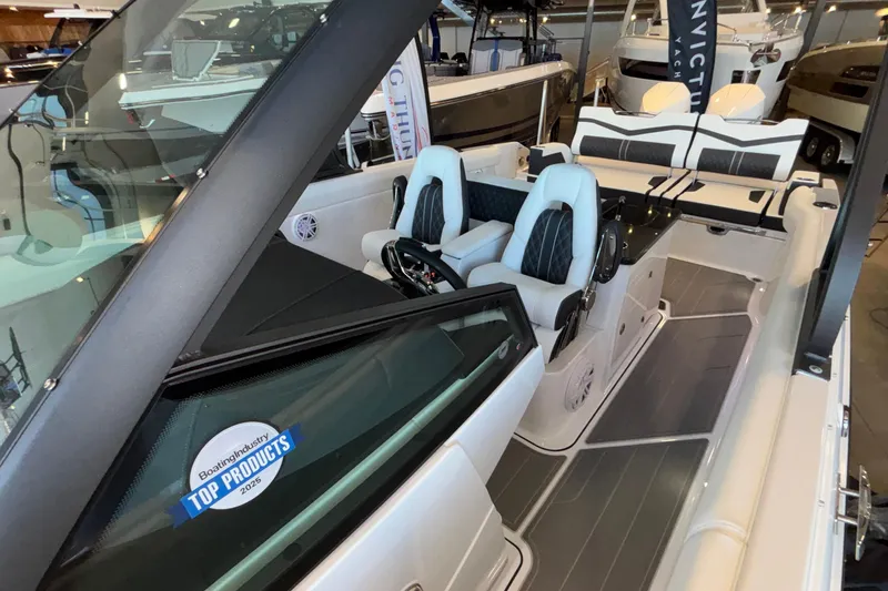 Slide: The Image of 2026 Monterey Elite 30 OB boat interior with modern seating and sleek design. - 90