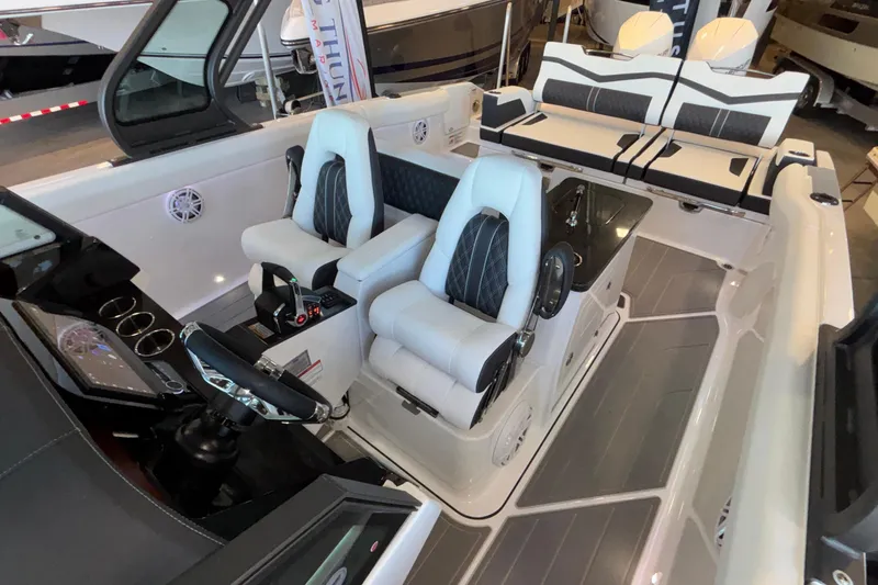 Slide: The Image of 2026 Monterey Elite 30 OB boat interior with luxury seating and modern dashboard. - 91