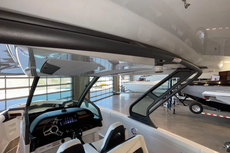 Slide: The Image of 2026 Monterey Elite 30 OB boat interior with modern dashboard and seating. - 94