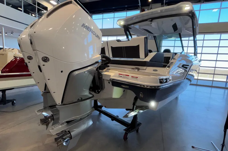 Slide: The Image of 2026 Monterey Elite 30 OB boat with powerful Mercury outboard engine in showroom. - 96