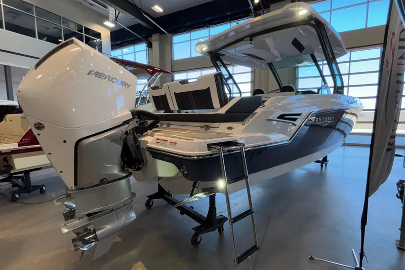 Slide: The Image of 2026 Monterey Elite 30 OB boat with Mercury outboard engine in showroom. - 97