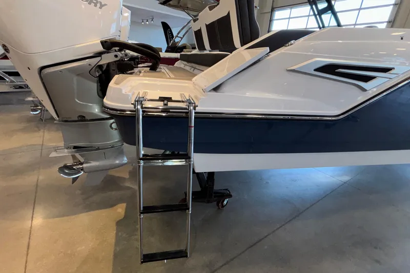 Slide: The Image of 2026 Monterey Elite 30 OB boat with ladder and outboard motor in showroom. - 98