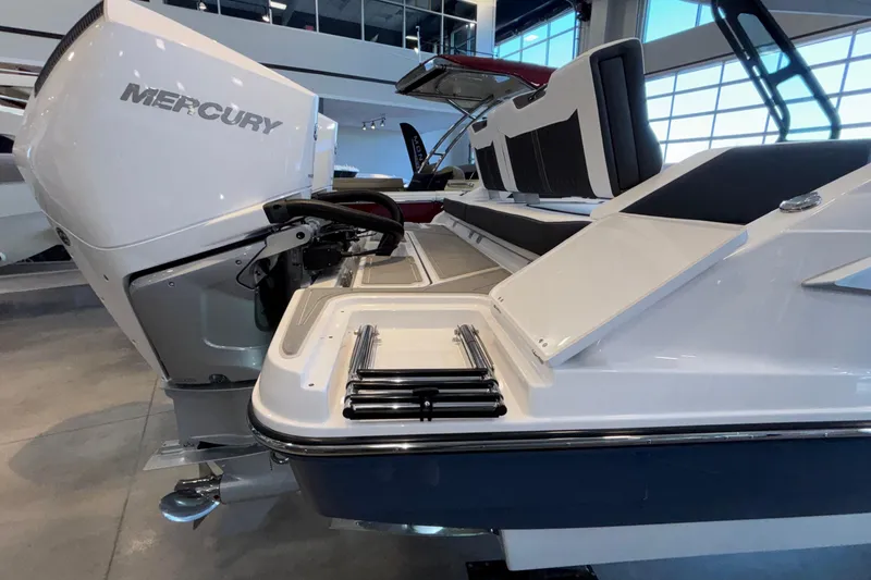Slide: The Image of 2026 Monterey Elite 30 OB boat with Mercury outboard engine in showroom. - 99