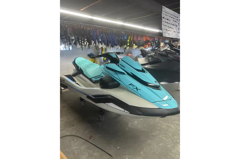 Slide: The Image of 2025 Yamaha WaveRunner FX Cruiser HO in showroom, turquoise and black design. - 3