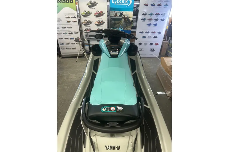 Slide: The Image of 2025 Yamaha WaveRunner FX Cruiser HO in showroom, featuring sleek design and turquoise seat. - 8