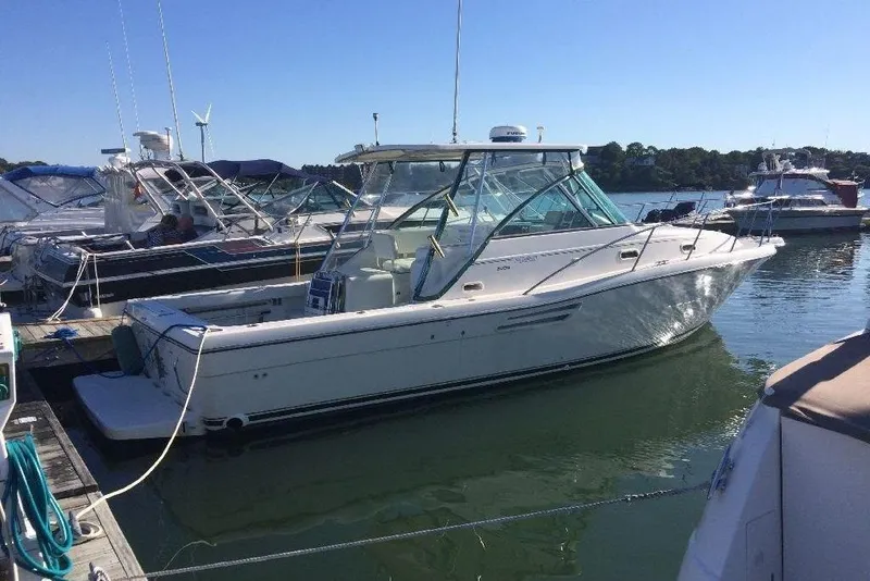 The Image of 2001 Pursuit 3000 Express boat docked in a marina on a sunny day. - 0