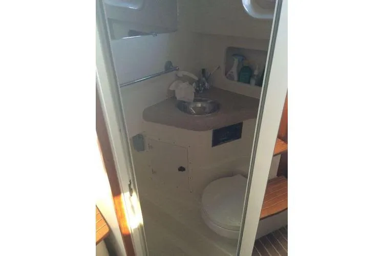 Slide: The Image of 2001 Pursuit 3000 Express boat bathroom with sink and toilet. - 13