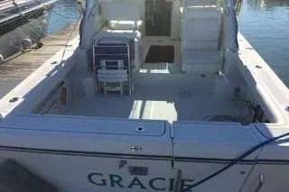 Slide: The Image of 2001 Pursuit 3000 Express boat docked, featuring spacious deck and seating area. - 2