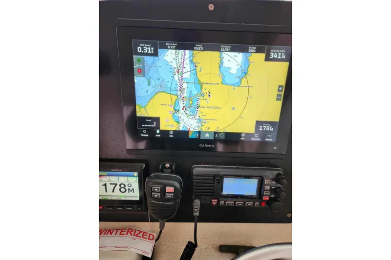 Slide: The Image of Control panel of a 2001 Pursuit 3000 Express boat with Garmin navigation display. - 4