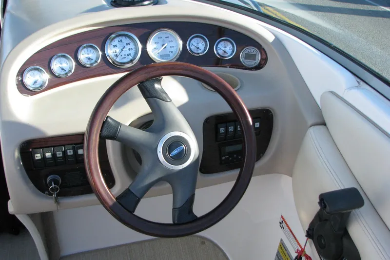 Slide: The Image of 2004 Chaparral 260 SSi boat dashboard with gauges and steering wheel. - 4