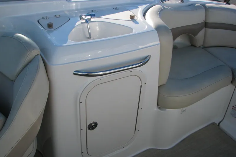 Slide: The Image of 2004 Chaparral 260 SSi boat interior with sink and seating area. - 9