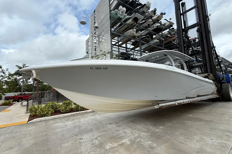 Slide: The Image of 2021 Fountain 43 NX boat cruising on clear blue water under a bright sky. - 2