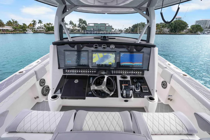 Slide: The Image of 2021 Fountain 43 NX boat cockpit with advanced navigation screens and luxurious seating. - 46