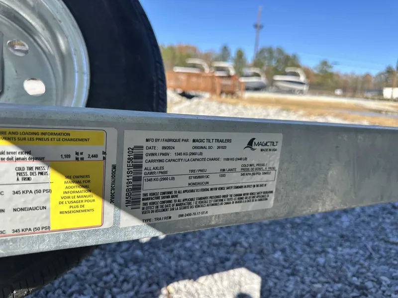 Slide: The Image of Magic Tilt trailer label with tire and loading information. - 19