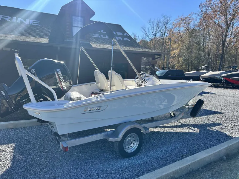 Slide: The Image of 2025 Boston Whaler 160 Super Sport boat on trailer outdoors. - 8