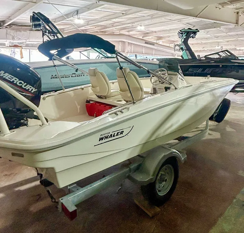 Slide: The Image of 2025 Boston Whaler 160 Super Sport boat in a storage facility. - 1