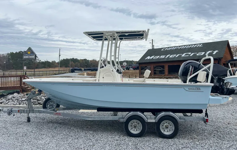 The Image of 2025 Boston Whaler 190 Montauk on trailer outside a boat dealership. - 1