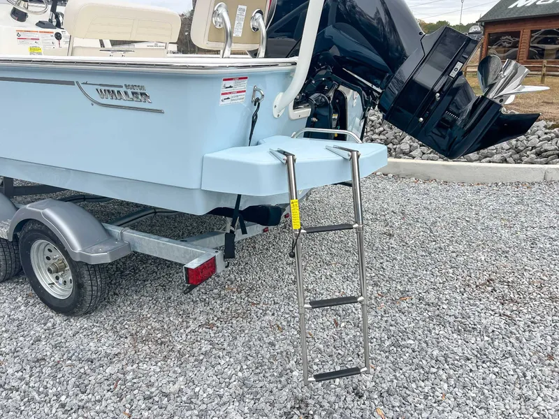 Slide: The Image of 2025 Boston Whaler 190 Montauk with outboard motor and ladder. - 4