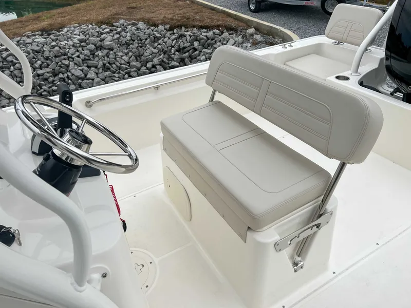Slide: The Image of Interior of 2025 Boston Whaler 190 Montauk with steering wheel and bench seat. - 9