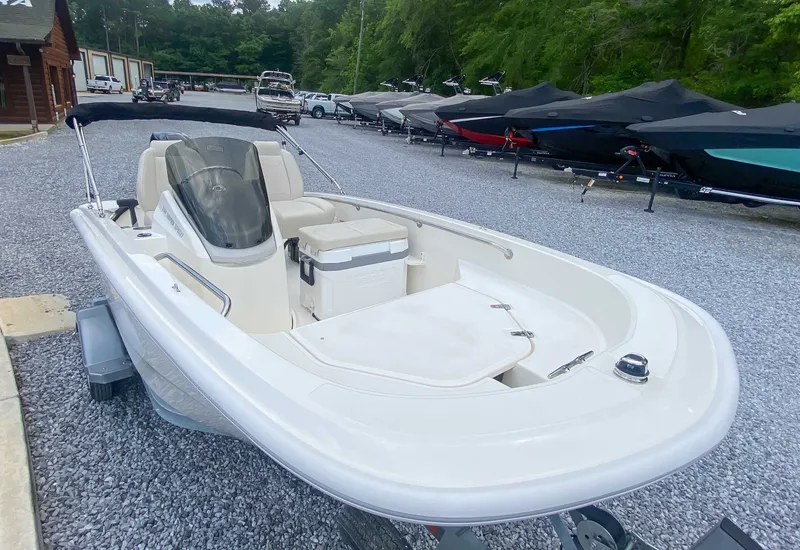 Slide: The Image of Boston Whaler 130 Super Sport 2025 on a gravel lot. - 5
