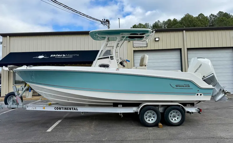 The Image of 2025 Boston Whaler 230 Outrage on trailer outside warehouse. - 1