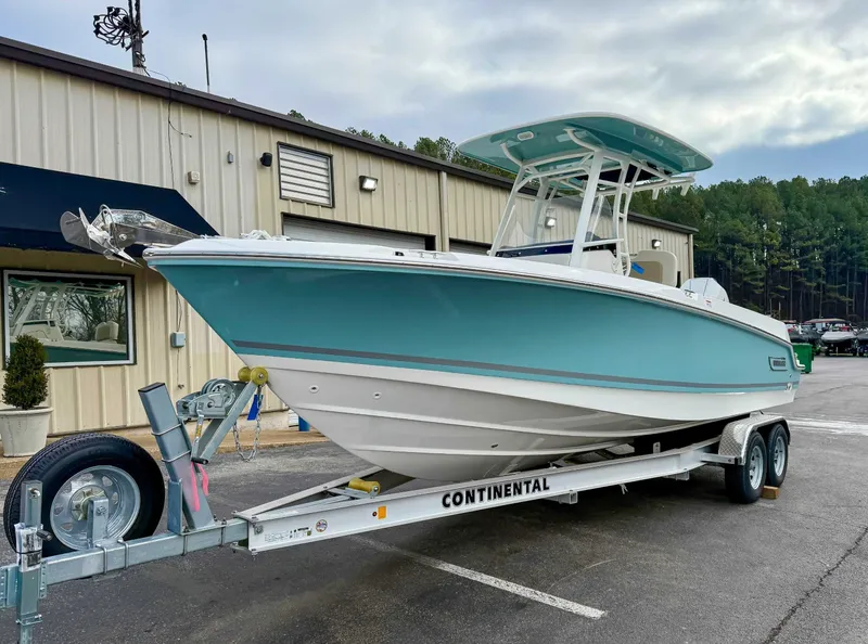 Slide: The Image of 2025 Boston Whaler 230 Outrage on trailer outside building. - 3