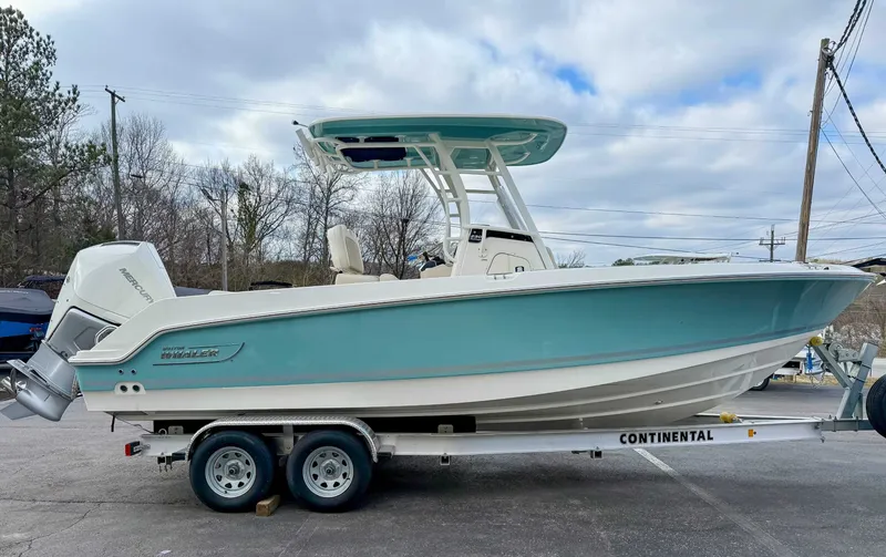 Slide: The Image of 2025 Boston Whaler 230 Outrage on trailer, turquoise color. - 5