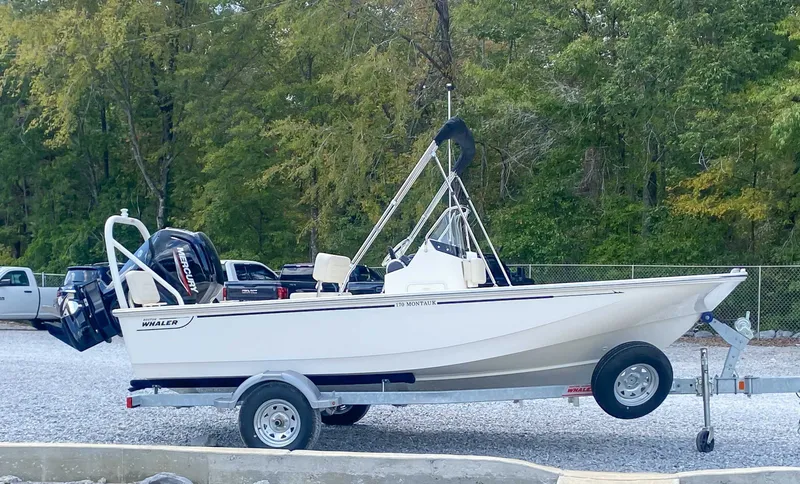 Slide: The Image of 2025 Boston Whaler 170 Montauk on trailer parked outdoors. - 6