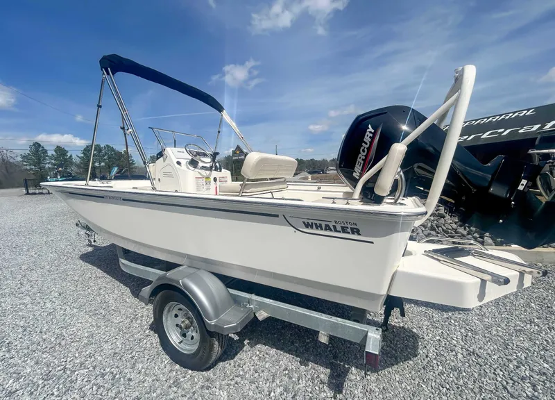 Slide: The Image of 2025 Boston Whaler 170 Montauk boat on trailer, sunny day. - 8