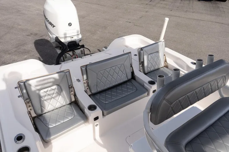 Slide: The Image of 2020 Blue Wave 2600 PureBay boat interior with gray diamond-stitched seating and Mercury outboard motor. - 10