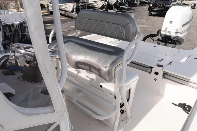 Slide: The Image of 2020 Blue Wave 2600 PureBay boat interior with steering wheel and cushioned seating. - 13